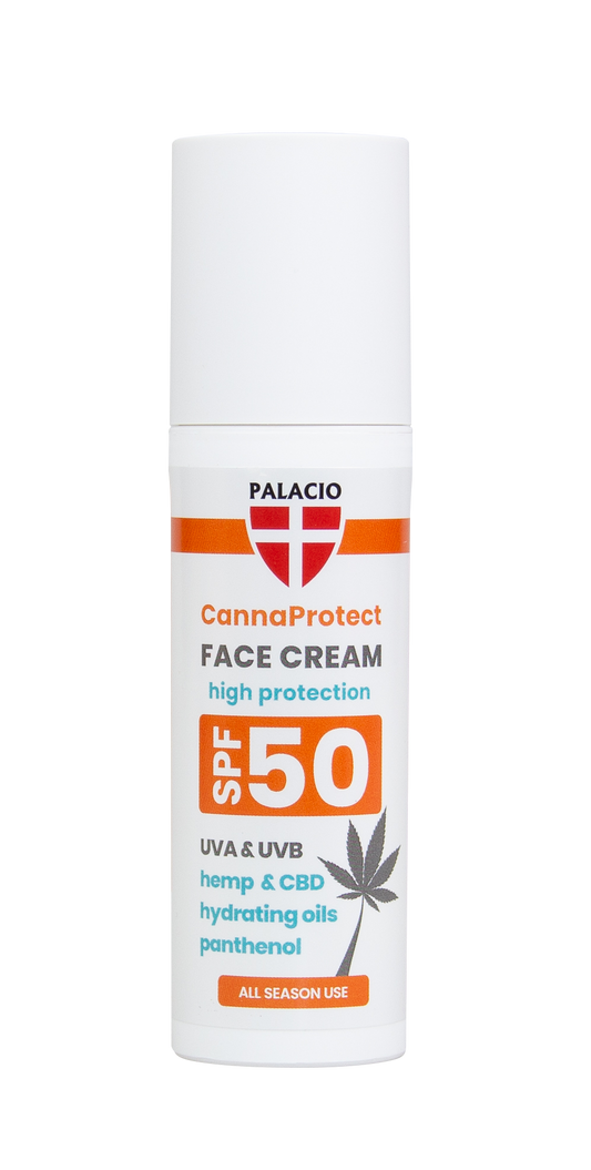 Crème visage SPF50 en tube blanc, vue avant avec étiquette orange lisible.